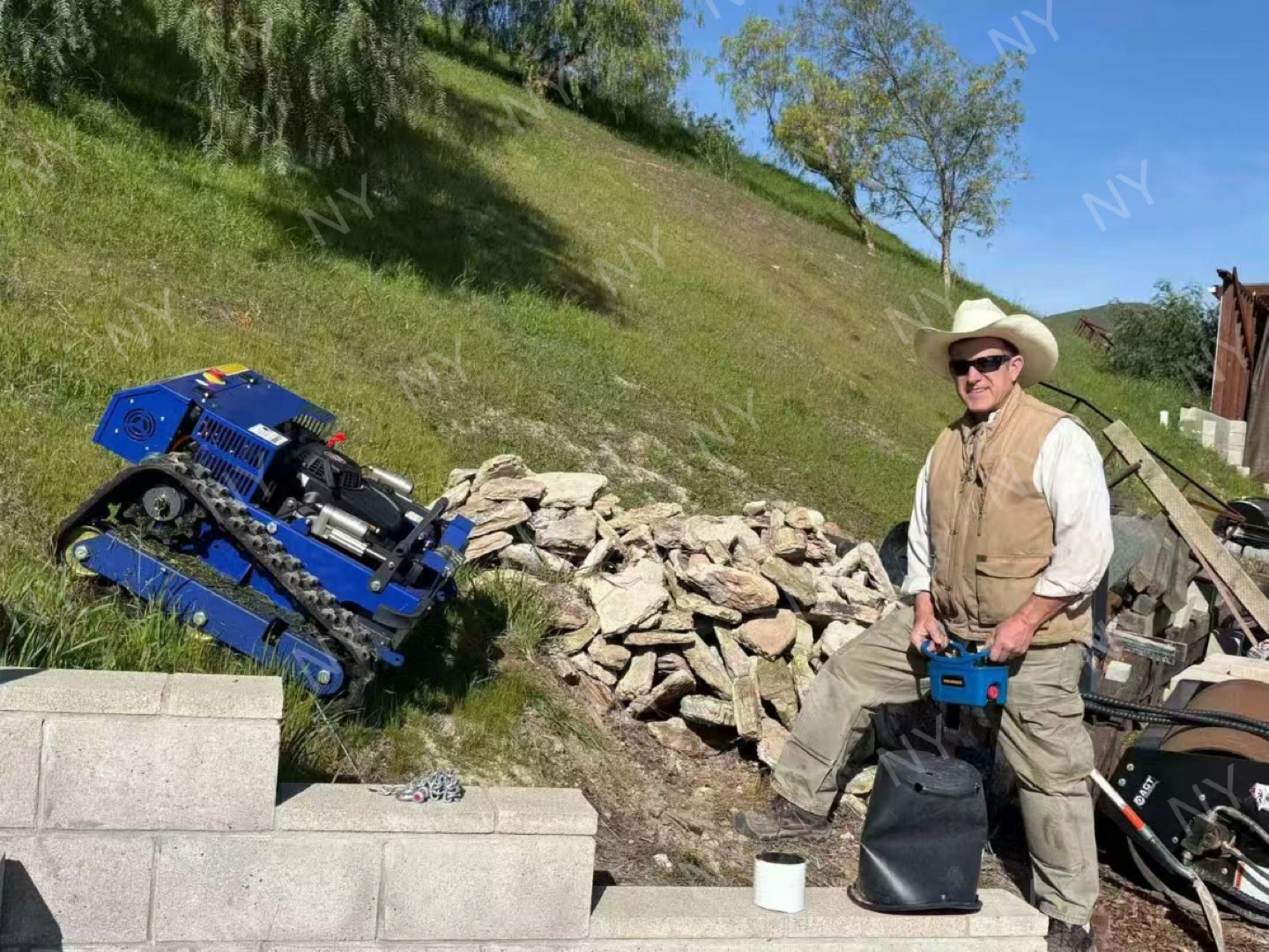 Customer using remote control mower on grassy slope