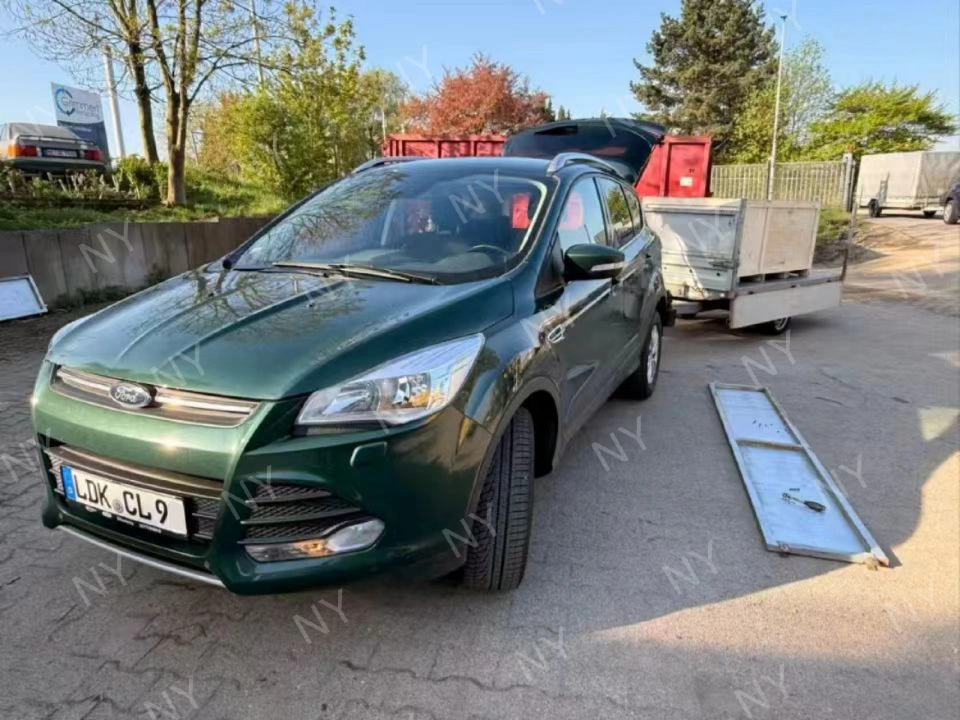 Customer vehicle and trailer prepared to pick up delivered mower crate