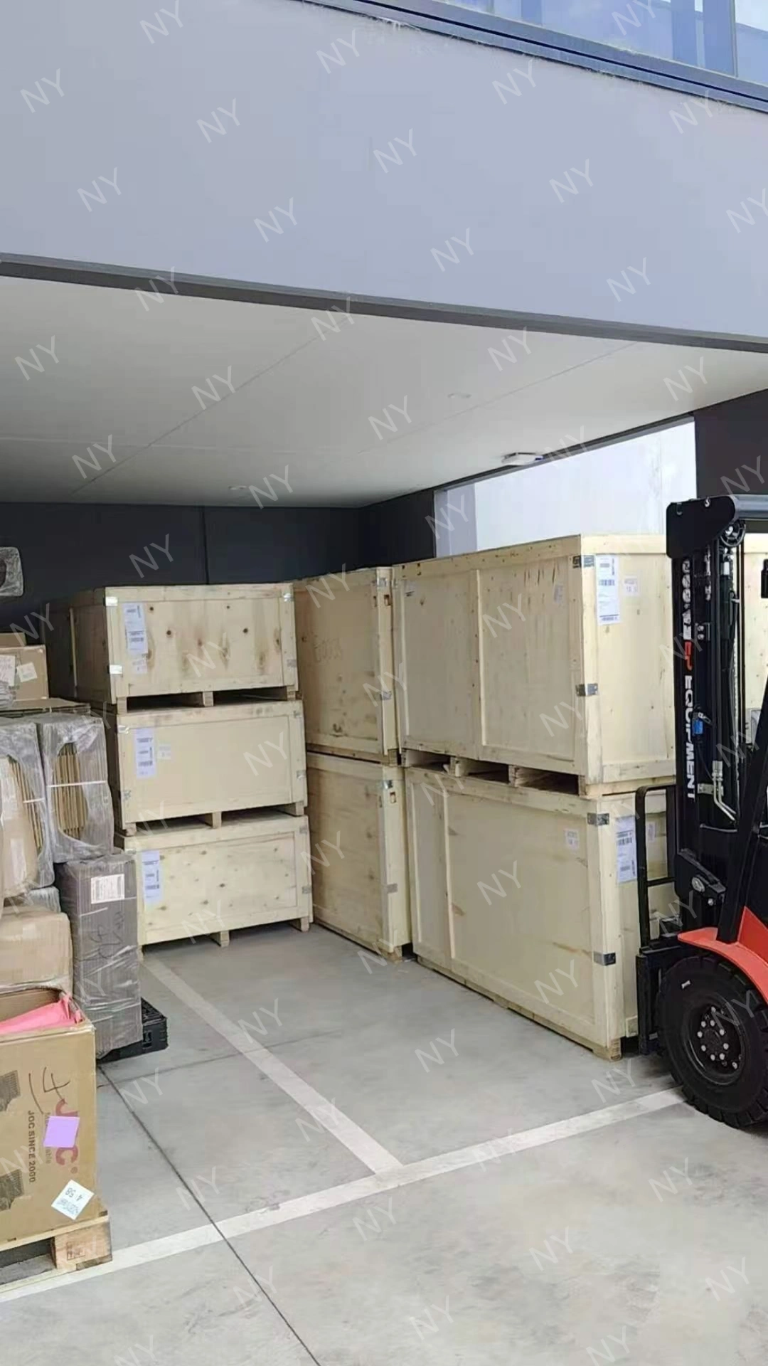 Delivered Nuoyu mower crates stacked in customer warehouse area