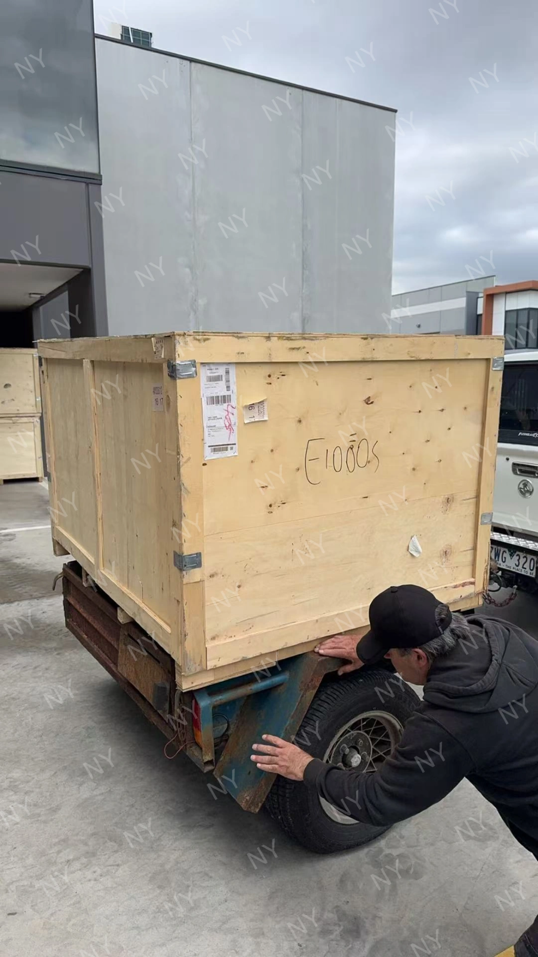 Delivered wooden packing crate being inspected after arrival