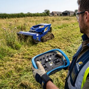 Operator using a wireless controller for a remote control mower